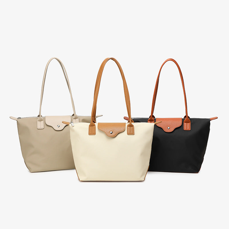 2025 Korean version contrasting color college style large-capacity commuting waterproof computer single shoulder tote bag women's texture large bag dumpling bag