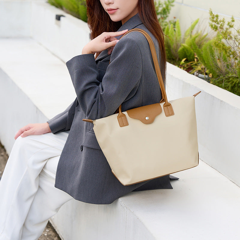 2025 Korean version contrasting color college style large-capacity commuting waterproof computer single shoulder tote bag women's texture large bag dumpling bag